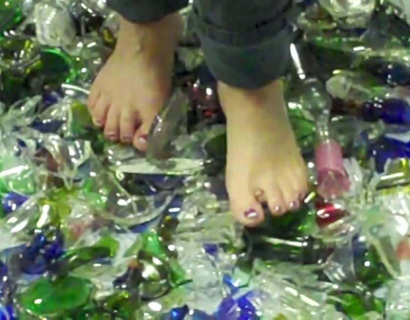 person walking barefoot on broken glass.