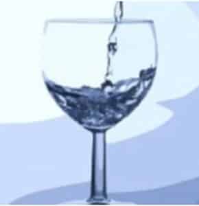 Water in a wine glass. pouring in