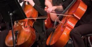 Violins being played by musicians.